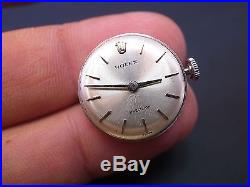 Vintage Rolex 1400 watch movement with silver dial hands crown and holder ring