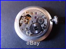 Vintage Rolex 1400 watch movement with silver dial hands crown and holder ring